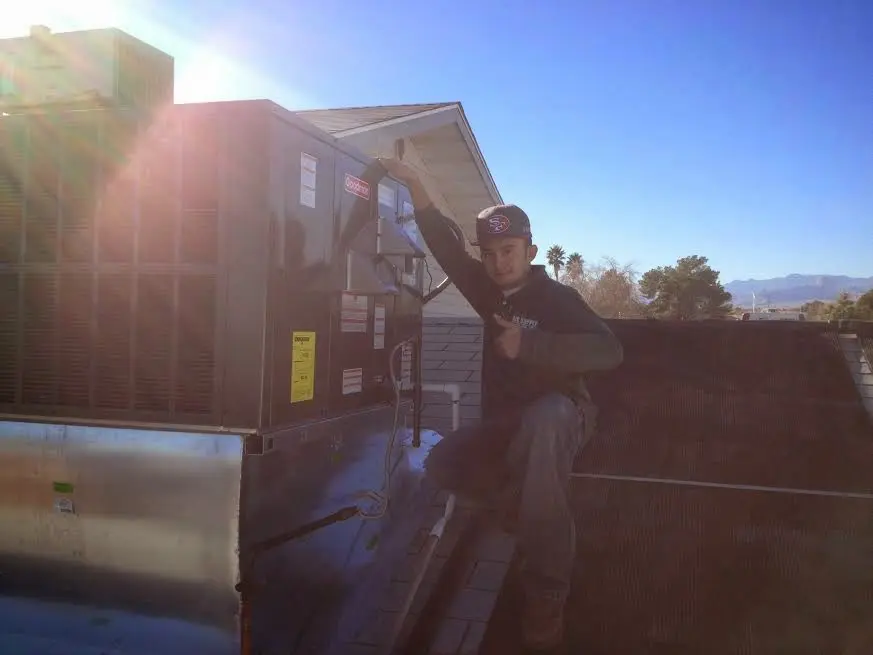 HVAC technician performing Heat Pump Repair on a rooftop unit in Phoenixville